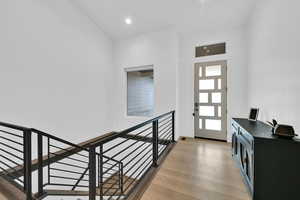 Foyer with light wood-type flooring and recessed lighting