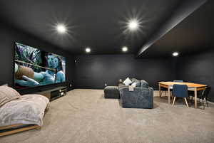Carpeted cinema featuring recessed lighting, closet on the back wall next to the TV.