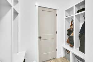 Mudroom featuring light wood-style floors