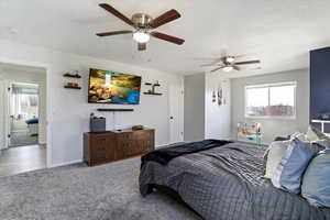 Bedroom featuring multiple windows, carpet, and ceiling fan