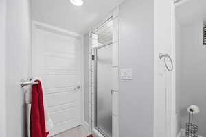 Full bathroom featuring a stall shower