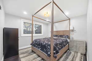 Bedroom featuring dark wood-style flooring and recessed lighting