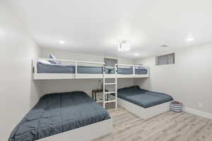 Bedroom with light wood-style floors and recessed lighting