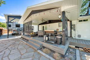 View of patio with ceiling fan, a wooden deck, and an outdoor hangout area