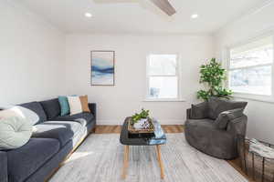 Living room with crown molding, recessed lighting, wood finished floors, and ceiling fan