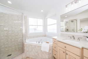 Full bath featuring vanity, a shower stall, a garden tub, ornamental molding, and recessed lighting