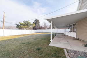 Fenced backyard with a patio