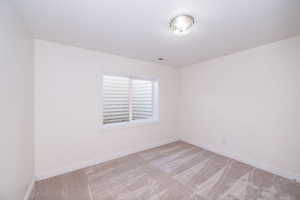 Unfurnished room featuring carpet floors and baseboards