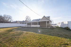 Rear view of property featuring a patio area and a fenced backyard