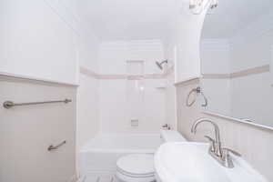 Full bathroom with bathing tub / shower combination, crown molding, and tile patterned flooring
