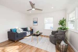 Living room featuring crown molding, light wood-type flooring, ceiling fan, and recessed lighting