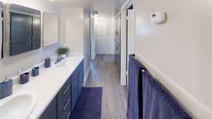 Full bath featuring dark wood finished floors and double vanity