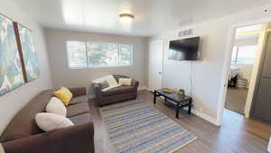 Living room with wood finished floors and baseboards