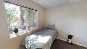 Carpeted bedroom featuring baseboards