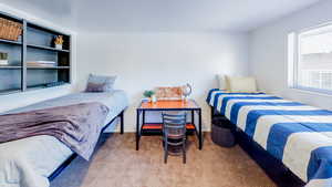Bedroom featuring carpet floors and baseboards