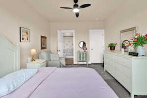 Bedroom featuring a ceiling fan and connected bathroom