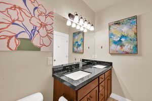 Bathroom with double vanity and toilet