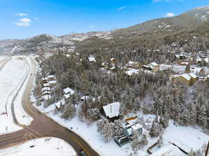 Snowy aerial view featuring a mountain view
