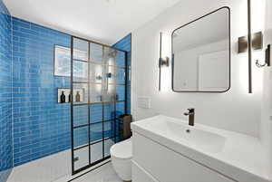 Bathroom with a stall shower and vanity