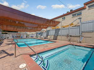 Community pool featuring a patio area and a community hot tub
