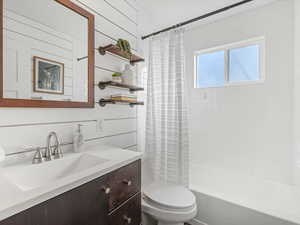 Full bathroom with shower / bathtub combination with curtain and vanity