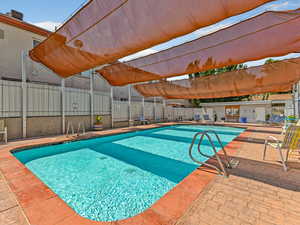 Community pool featuring a patio