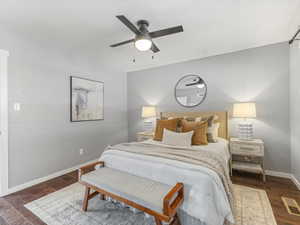 Bedroom featuring dark wood-style flooring and a ceiling fan