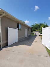 View of home's exterior featuring stucco siding and a patio
