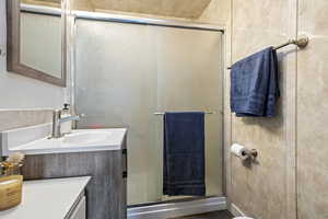Full bath with vanity and a stall shower