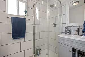 Bathroom with a stall shower and vanity