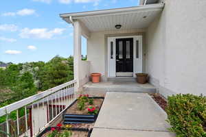 View of exterior entry with stucco siding