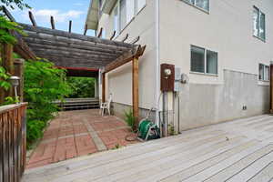Wooden deck with a patio area and a pergola