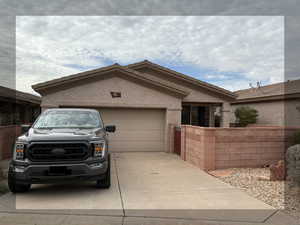Ranch-style home featuring driveway and an 2 car attached garage