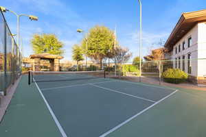 View of tennis court featuring a gazebo and community basketball court