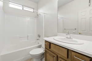 Full bath featuring vanity, tub / shower combination, and light tile patterned floors