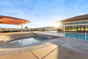 Community pool featuring a patio area and a hot tub