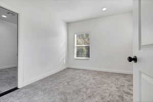 Unfurnished bedroom with recessed lighting and light colored carpet