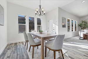 Dining area featuring a chandelier and wood finished floors