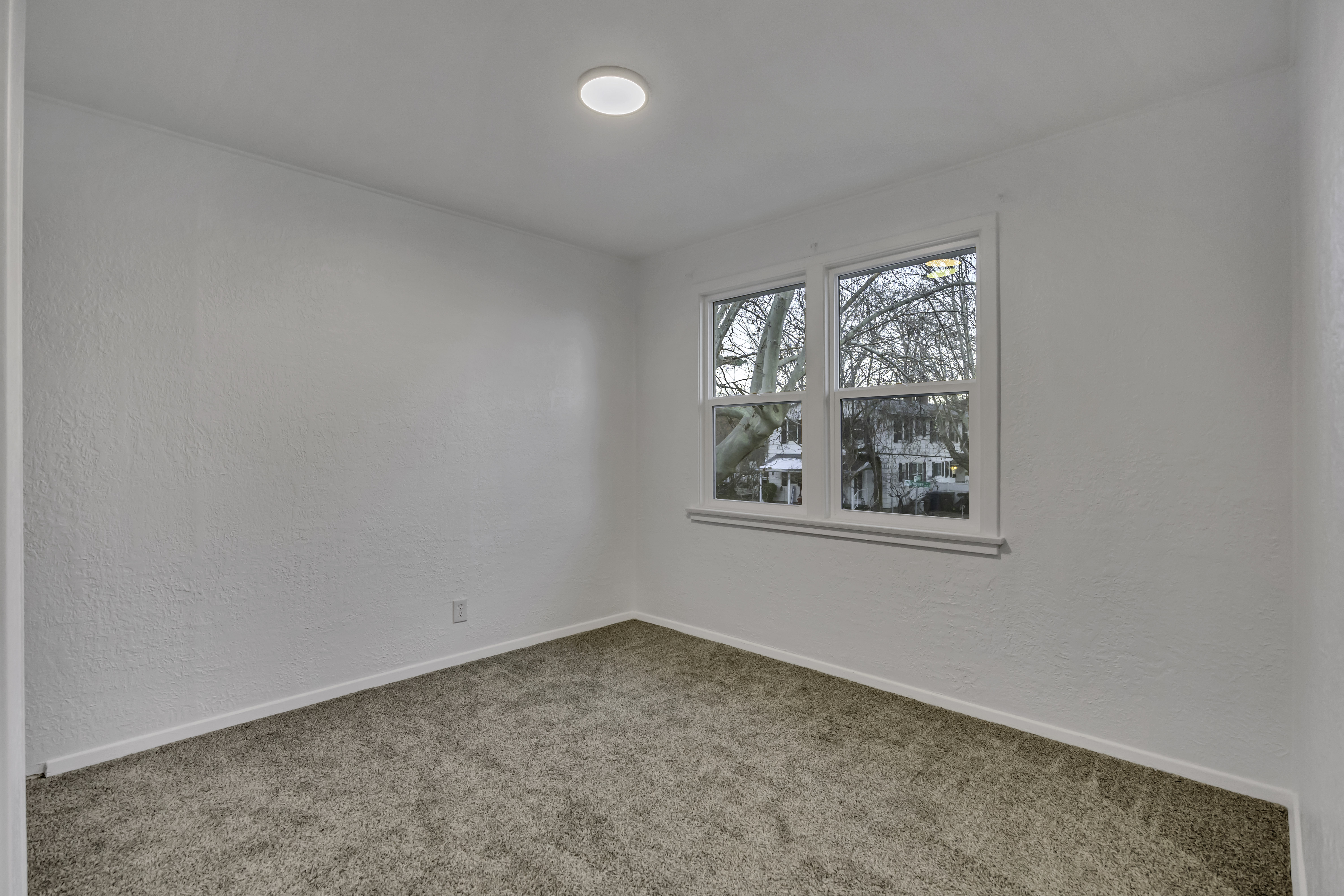 Spare room with a textured wall and carpet floors