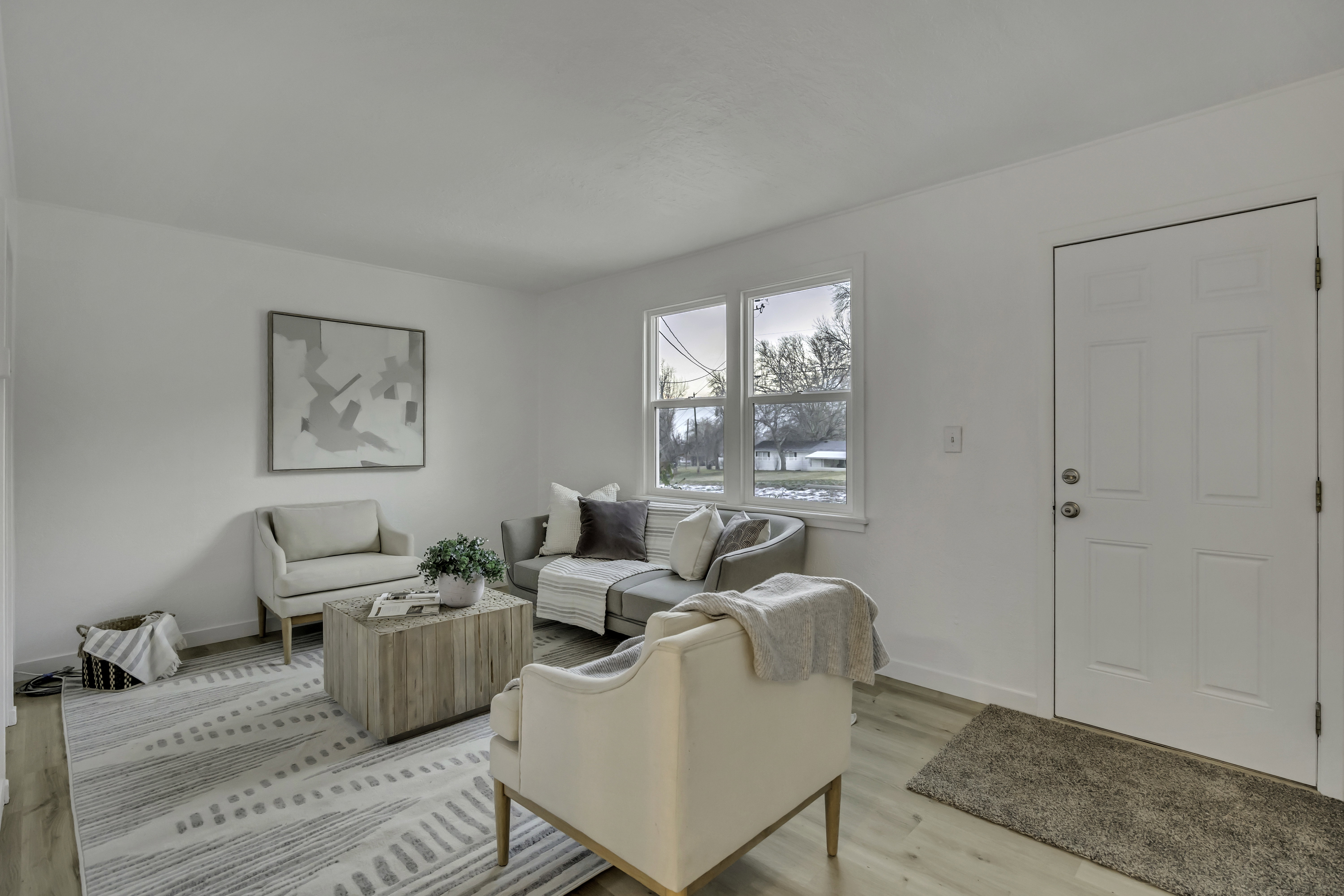 Living area featuring baseboards and light wood-type flooring