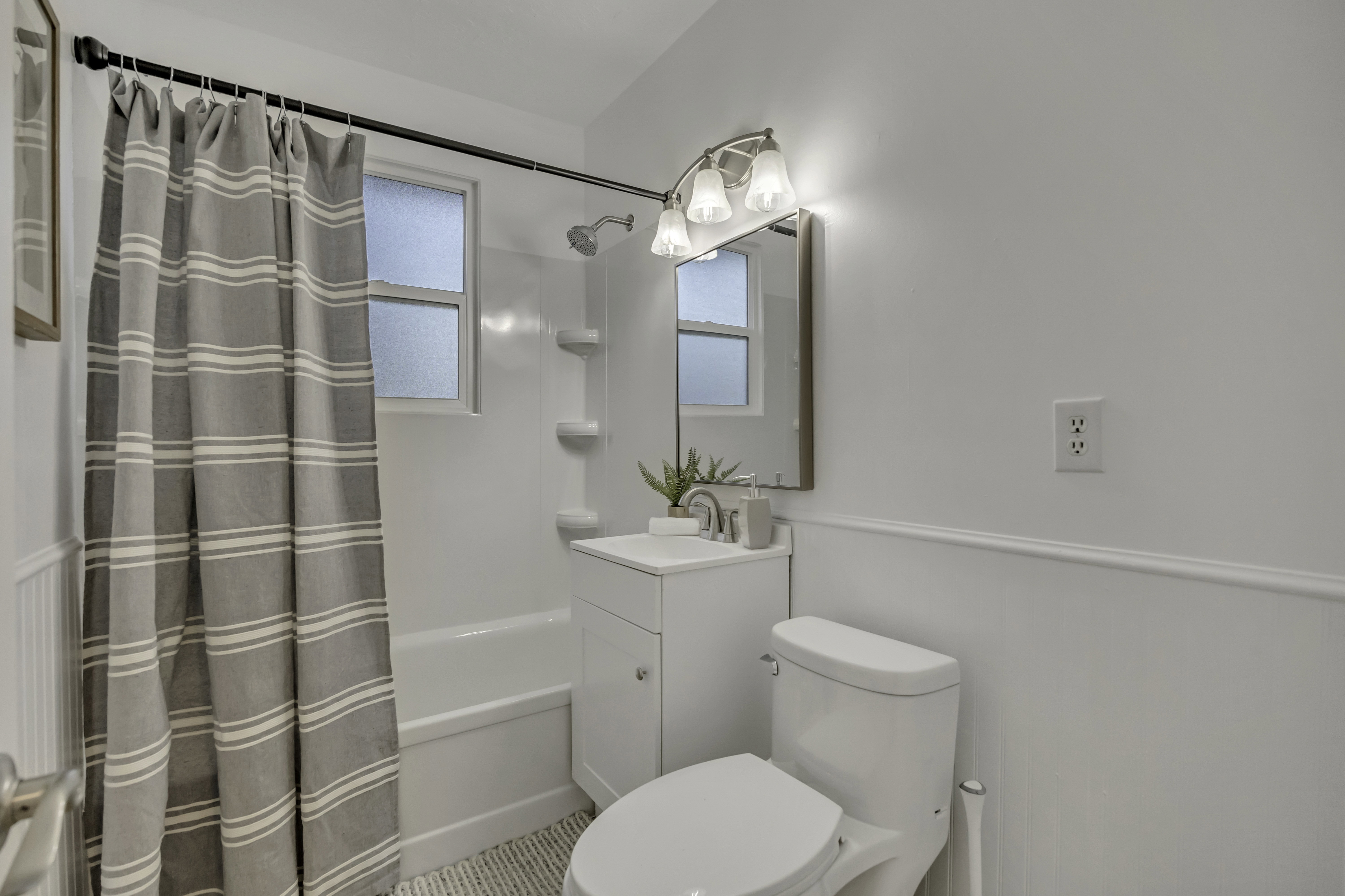 Full bathroom with shower / tub combo and vanity