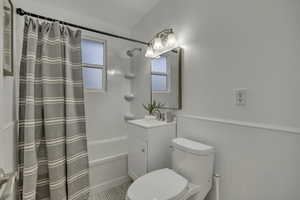 Full bathroom with shower / tub combo and vanity