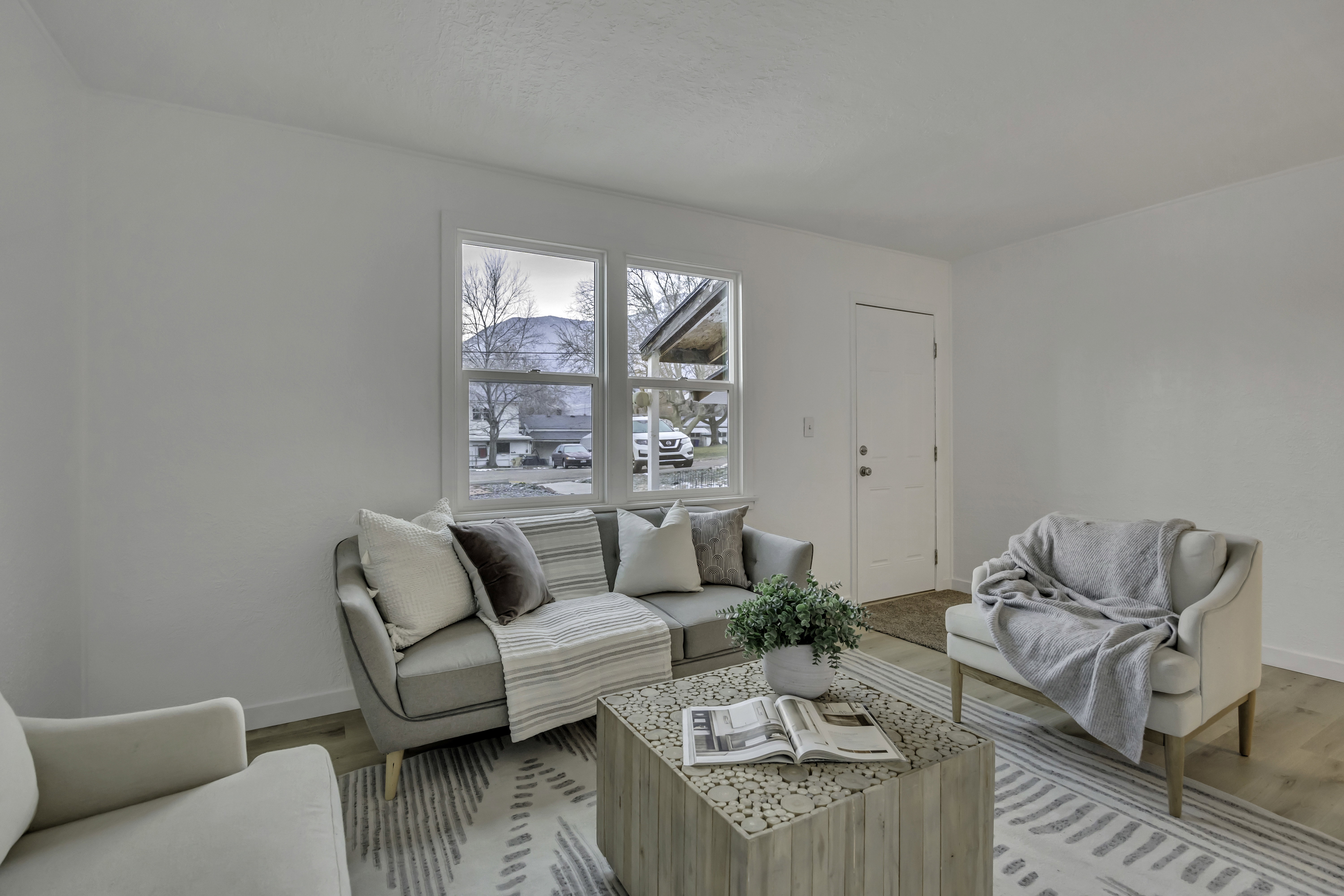 Living area featuring light wood-style flooring and baseboards