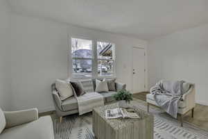 Living area featuring light wood-style flooring and baseboards