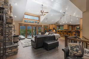 Living room with high vaulted ceiling, hardwood / wood-style flooring, and ceiling fan