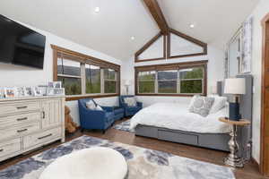 Bedroom with dark wood finished floors and a mountain view