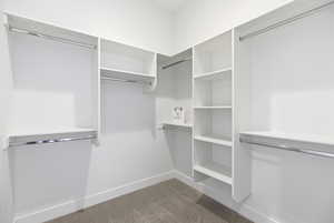 Walk in closet with light carpet