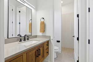 Full bath featuring vanity and light tile patterned floors