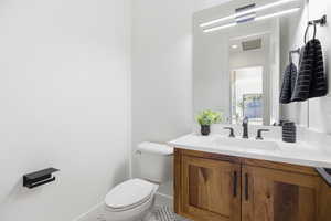 Bathroom featuring vanity and toilet