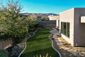 Fenced backyard with a mountain view